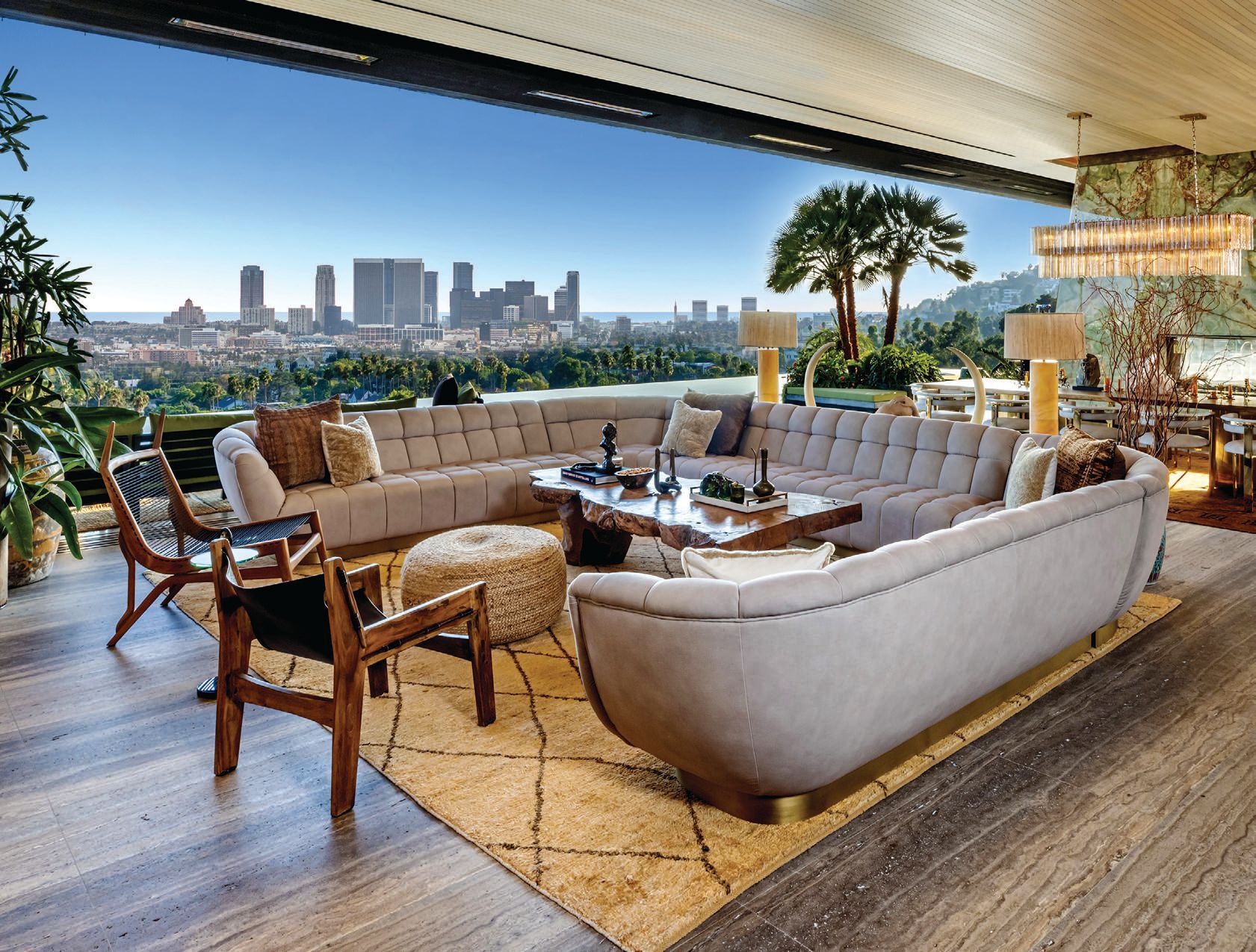 A living room has never been more lovely amid tropical aesthetics and midcentury modern furnishings—opening up to the Sunset Strip below PHOTO BY SIMON BERLYN