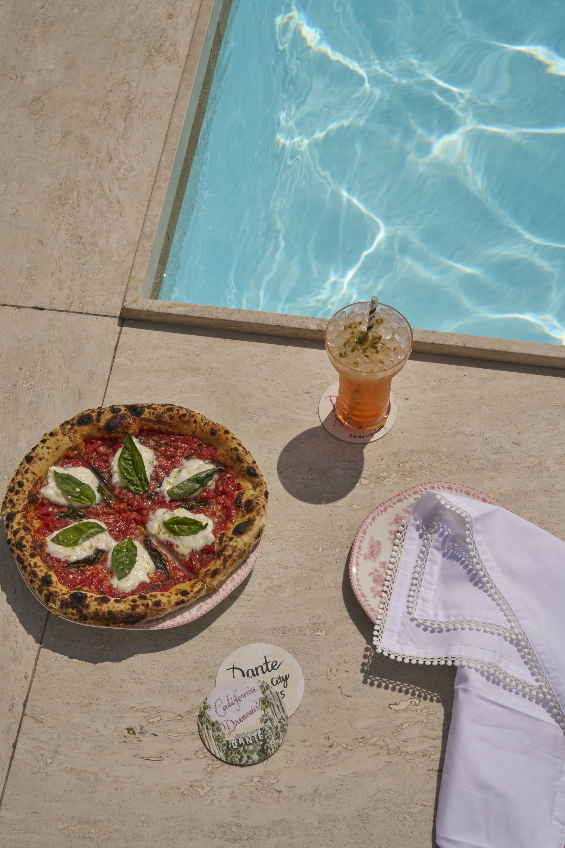 pizza and drink by pool