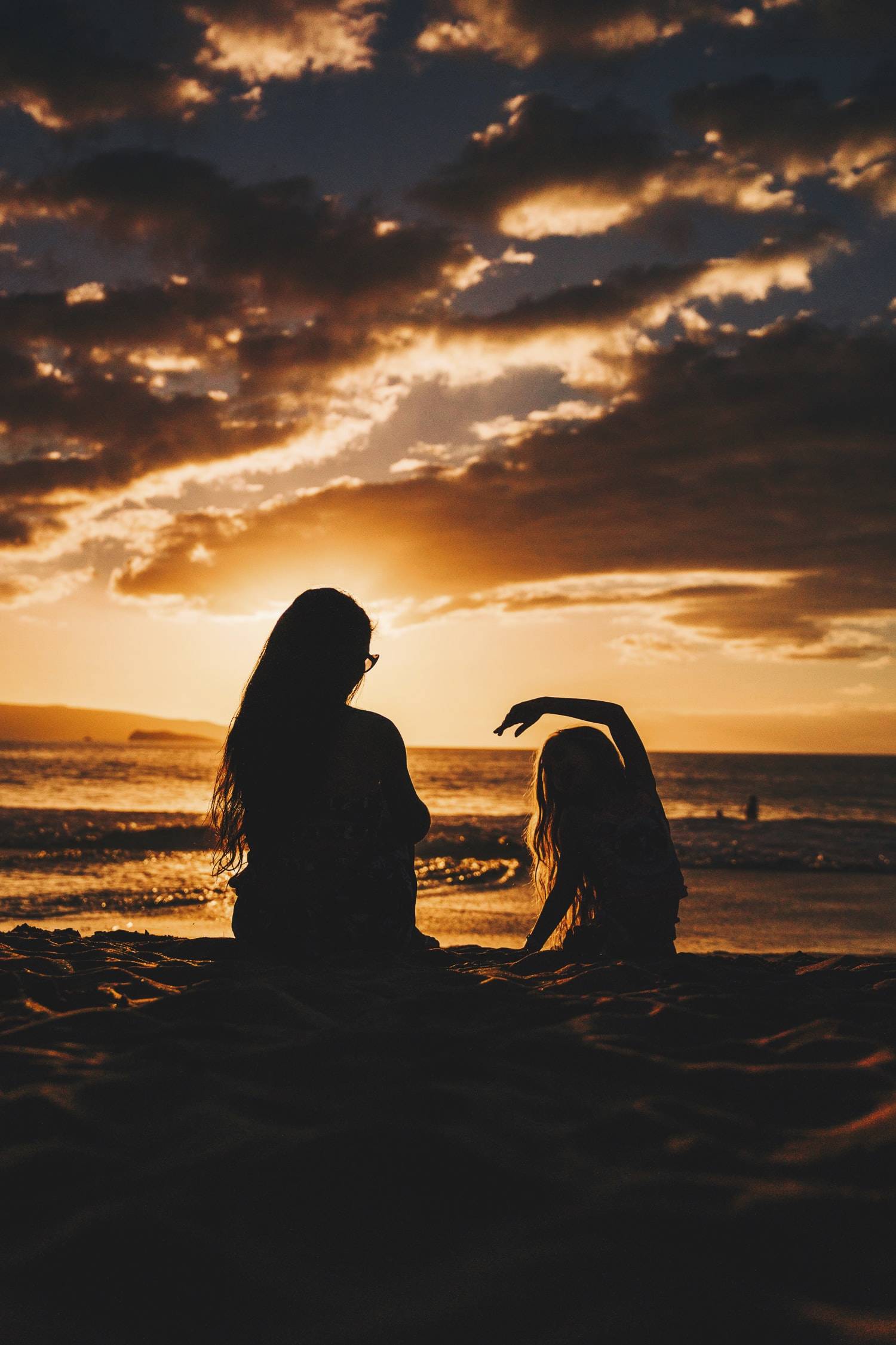 mom and daughter at sunset