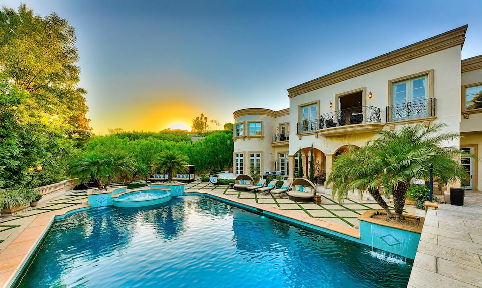 Mansion backyard with pool at sunset